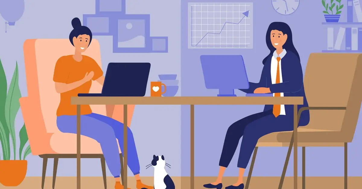 Two professionals are working at a desk with laptops; a cat sits on the floor, surrounded by plants and a chart on the wall.