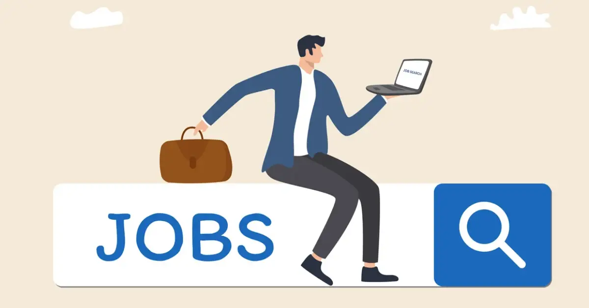 A person in a blue jacket sits on a large "JOBS" sign, holding a laptop displaying "JOB SEARCH" and a briefcase beside them.